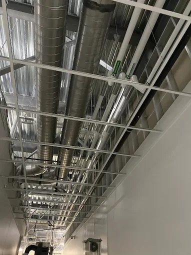 Acoustical ceiling grid installation in a commercial corridor