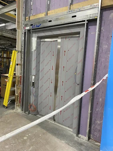 Commercial door frame set in framed drywall wall