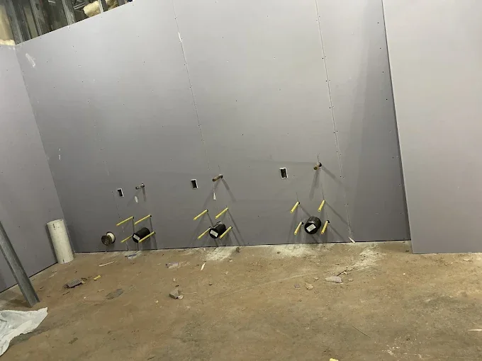 Drywall installed on a large commercial wall