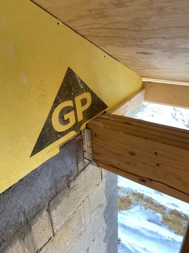Detail of DensGlass sheathing meeting plywood and wood framing